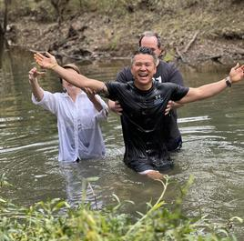 A joyful baptism in a river